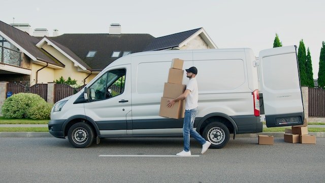 white moving van with a man carrying boxes